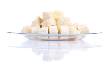 peeled ripe sliced banana in a plate isolated on a white backgro