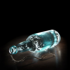 Wine bottle and glass filled with twine