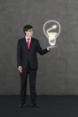 businessman holding drawing lightbulb