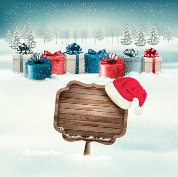 Winter background with gift boxes and a wooden ornate Merry chri
