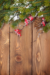 Christmas wooden background with snow fir tree and decor