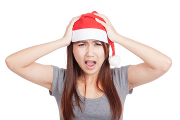 Frustrated Asian girl with red santa hat