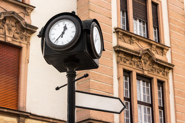 Fototapeta na wymiar iron city clock with index sign in europe