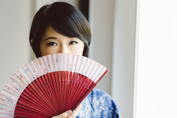 Beautiful woman with a fan