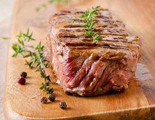 Grilled Beef steak on a  cutting board .