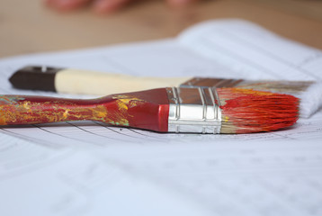 Two paint brushes lying on paper © lenets_tan