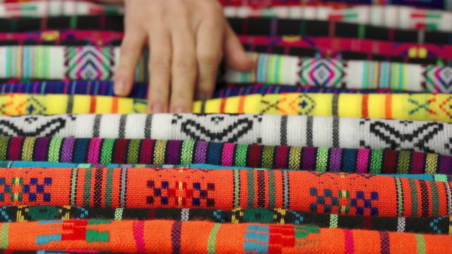 Woman Choosing Traditional Mexican Fabric