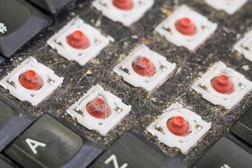 Side view of dismantled dirty keyboard, closeup