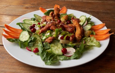 Roast meat with fresh vegetables on wooden table