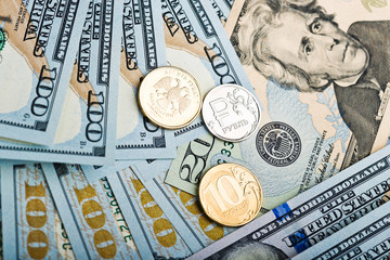 russian roubles coins on banknotes of us dollars