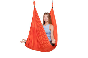 Young woman doing aerial yoga