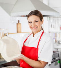 Happy Female Chef Holding Pasta Sheet