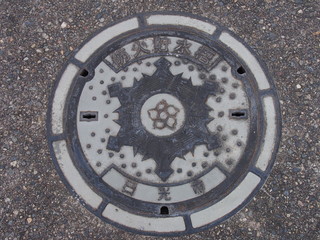 Manhole drain cover on the street at Nikko, Japan