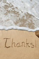 Conceptual thank you text in sand and water