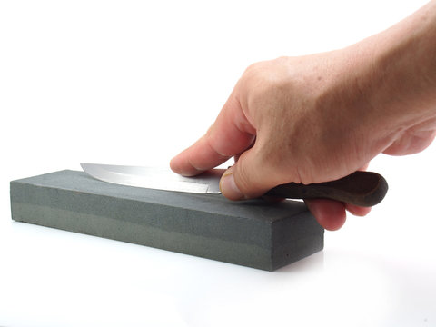 honing a nife on white background