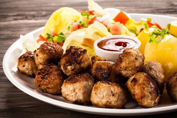Roast meatballs, French fries and vegetable salad