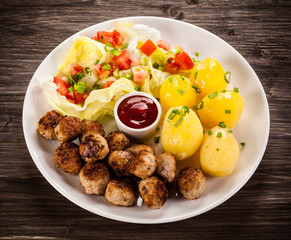 Roast meatballs, French fries and vegetable salad