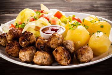Roast meatballs, French fries and vegetable salad