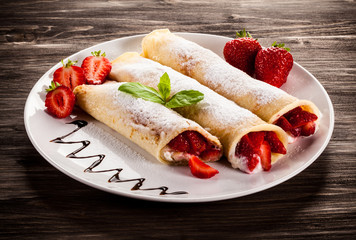 Pancakes with cream and strawberries