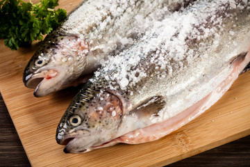 Fresh raw trouts on cutting board