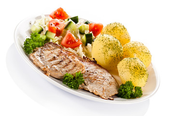Fried steaks, boiled potatoes and vegetable salad
