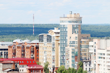 Modern buildings on edge of large city on sunny day