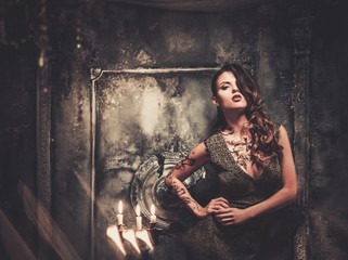 Tattooed beautiful woman in old spooky interior