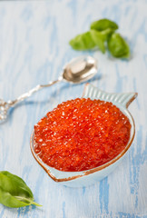 Red caviar in fish-shape bowl