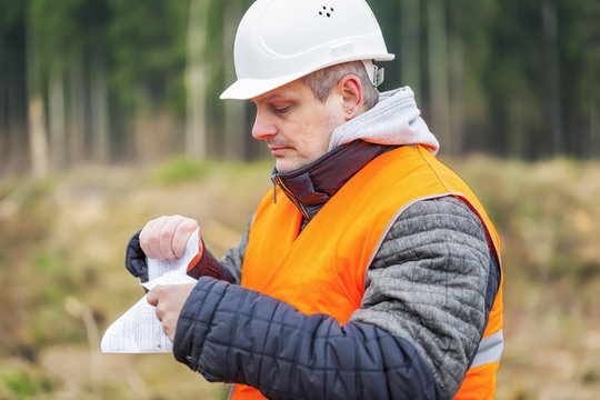 Forest engineer destroying sensitive documents in the forest