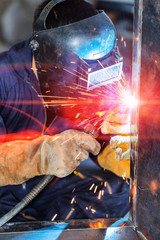 worker welding construction by MIG welding