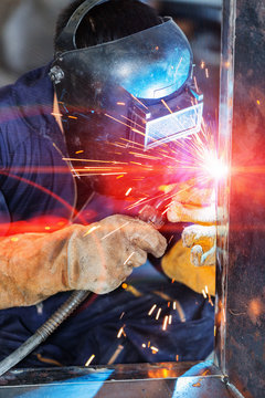 worker welding construction by MIG welding