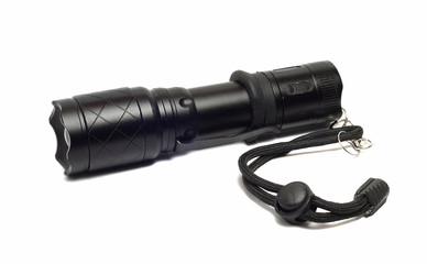 small black flashlight on a white background