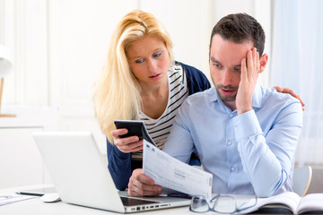 Attractive couple doing administrative paperwork