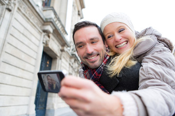 Fototapeta na wymiar Young couple on holidays taking selfie