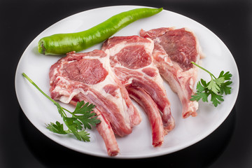 raw cutlet of lamb with vegetables