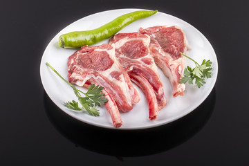 raw cutlet of lamb with vegetables