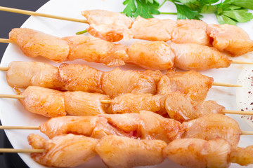 Raw Chicken Skewers On Plate