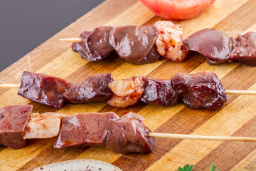 Raw Liver Kebab on a Wood Plate