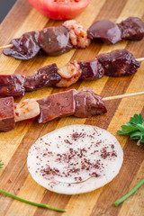 Raw Liver Kebab on a Wood Plate