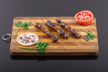 Raw Liver Kebab on a Wood Plate