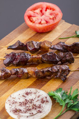 Raw Liver Kebab on a Wood Plate