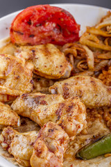 grilled chicken wings and legs on wooden plate