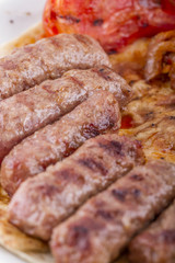 Grilled meatballs on a white plate