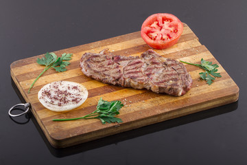 Grilled Steaks and Vegetables On a Wood Plate