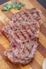 Grilled Steaks and Vegetables On a Wood Plate