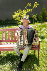 Old man playing accordion