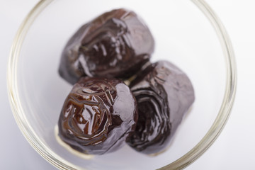 Three Black Olive In a Glass Bowl