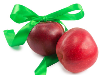 apples and green ribbon isolated on white background