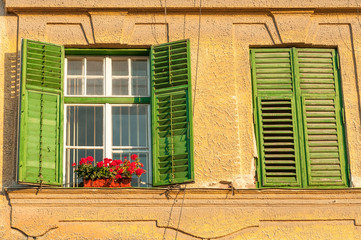 Window With Closed Wooden Shutters, Decorated With Fresh Flowers