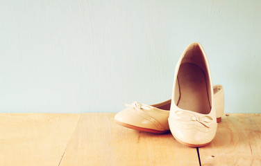 girl shoes over wooden deck floor. filtered image